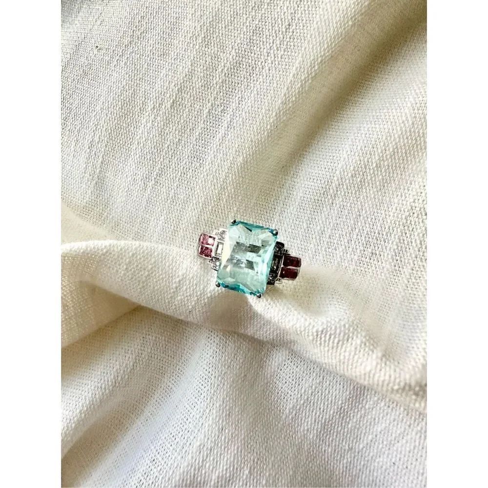 Light blue elongated radiantโcut cubic zirconia cocktail ring with light pinkโac